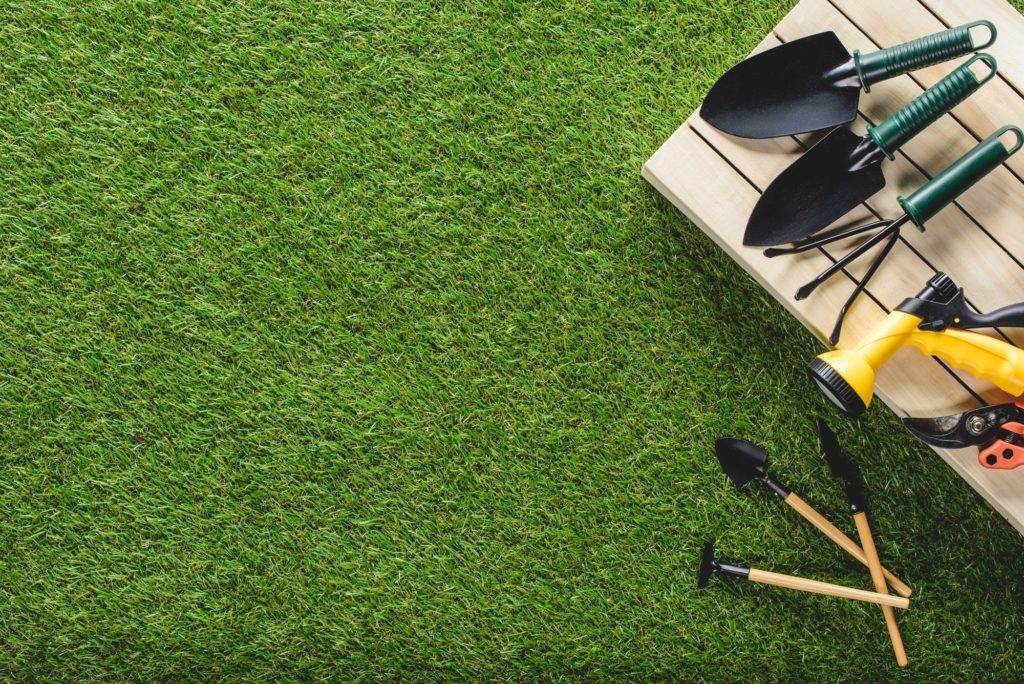 top view of gardening tools-and equipment on grass